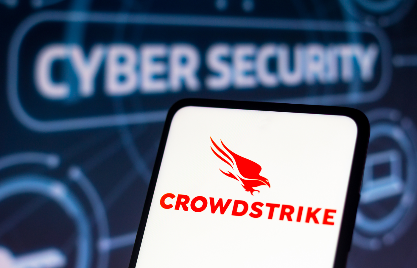 CrowdStrike logo seen displayed on a smartphone with cybersecurity background.